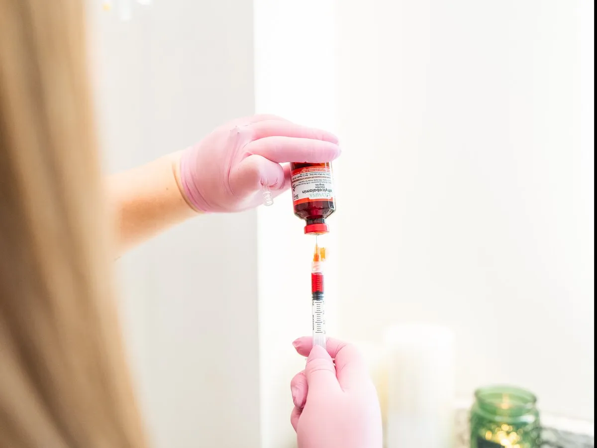CoQ10 being drawn from the vial into a syringe at Raw Glo Med Spa in Waukesha, WI