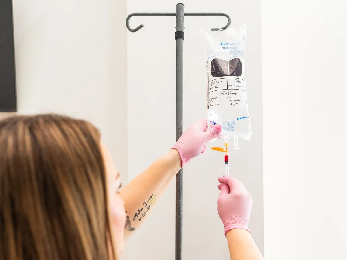 An IV vitamin drip being hung and prepared at Raw Glo Med Spa in Waukesha, WI