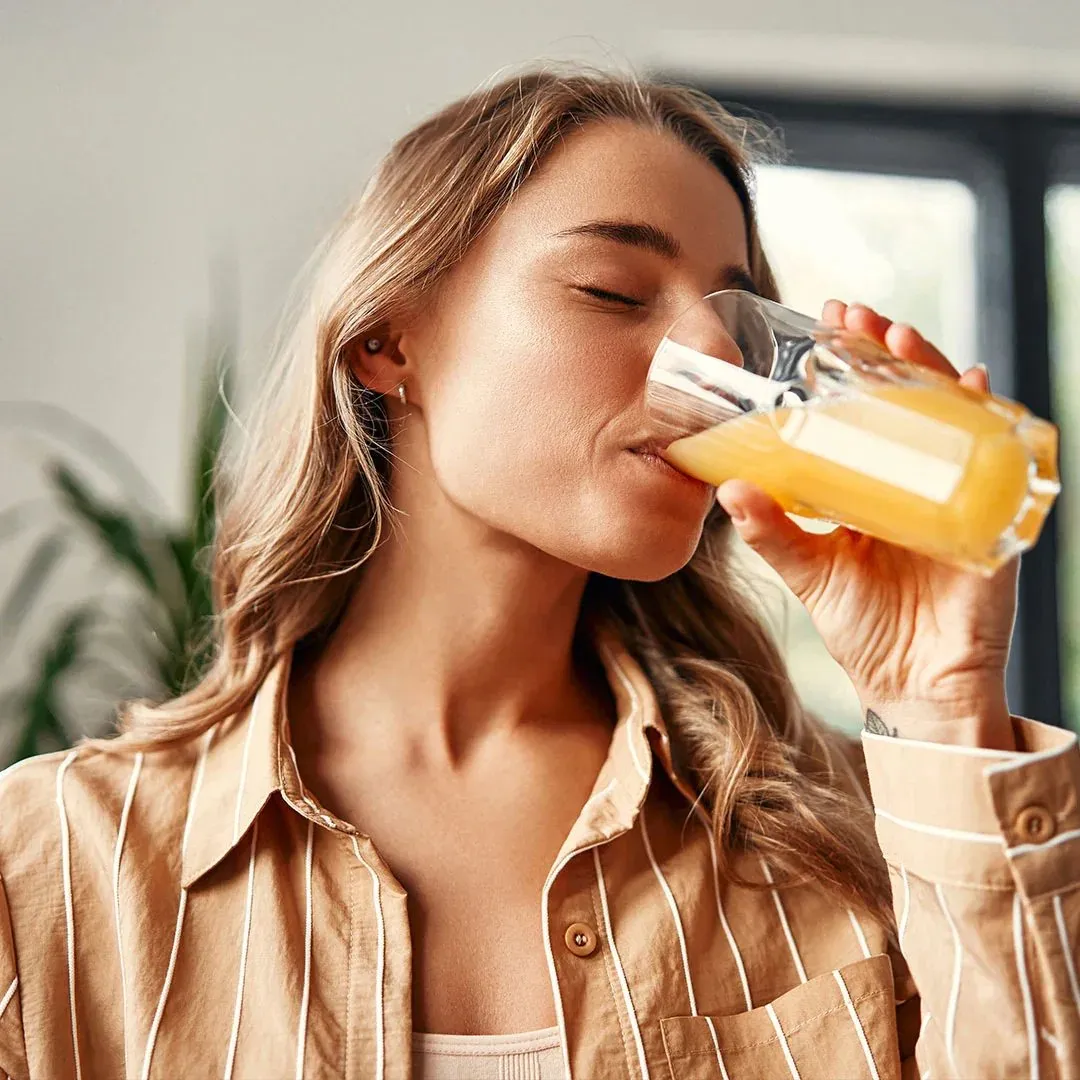 A client enjoying a Make Wellness oral peptide drink, available through Raw Glo Med Spa in Waukesha, WI