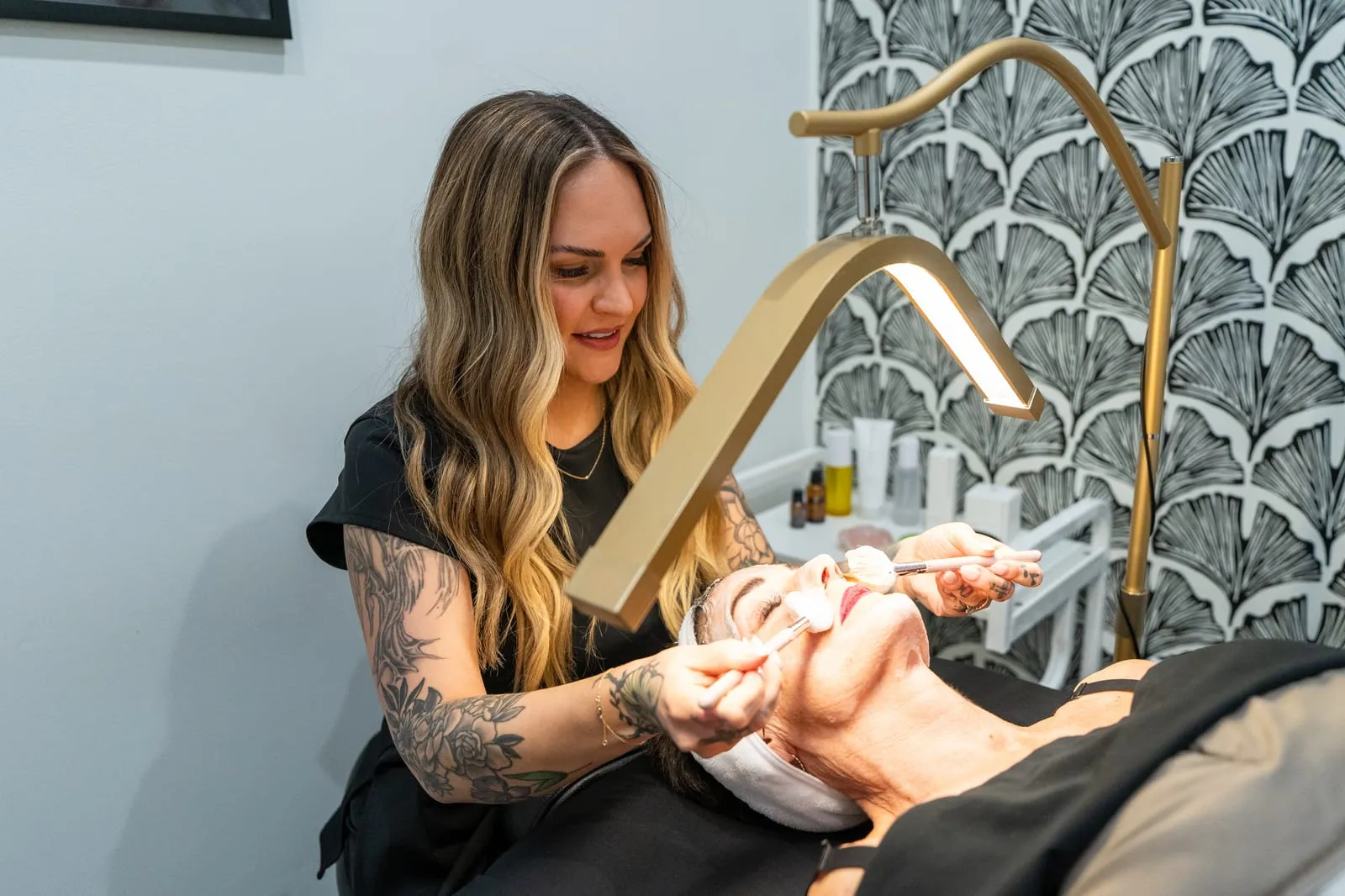 An aesthetician performing a facial at Raw Glo Med Spa in Waukesha, WI