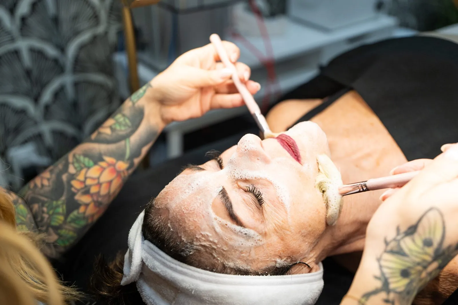 A relaxing facial treatment with a client resting